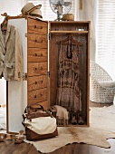 Trunk-style wardrobe with handbag and items of clothing