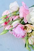 Bouquet of roses and peonies on vintage shelf