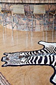 Zebra skin rug on glossy stone floor in front of bar counter