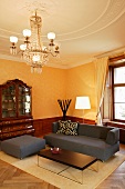 Elegant seating area with simple designer furniture in historic setting in modern, stately home hotel (Schloss Schauenstein)