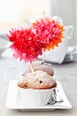 Muffins decorated with tissue paper pompoms