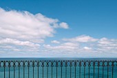Oriental-style wrought iron balustrade in front of ocean panorama