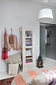 Bookcase and coat hooks in a bedroom