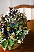 Dried flower arrangement with hydrangea flowers, oak leaves and peacock feather