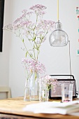Retro radio and vases of flowers on wooden table