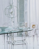 Transparent modern interior - clear plastic chairs at glass table and airy curtain