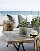 Rattan sofa and coffee table on terrace with sea view