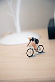 Knick-knack figurine of cyclist on racing bike on bedside table