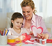 Mother and daughter making Valentines