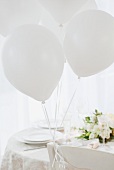 Wedding table set in white with white balloons