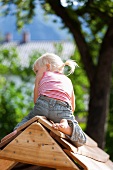 Germany, Girl playing on playground