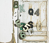 Decorative wooden letters and numbers on wooden door