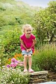 Smiling girl playing in garden