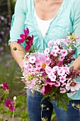 Woman picking garden flowers for bouquet
