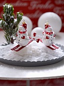 Snowman baubles on plate with artificial snow