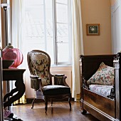 Armchair next to daybed in Southern French interior furnished in historical style