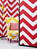 Mini-room with red and white zigzags on the movable walls and yellow and white zigzag armchair