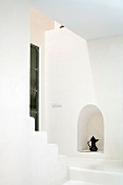 Staircase as minimalist, white spatial sculpture with Oriental teapot in niche