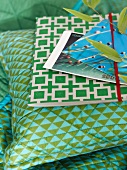 Postcards and folder on pillows and blue and green plaid pattern