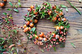 Wreath of rosehips on wooden table