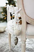 Christmas decorations hanging from Rococo chair
