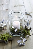 Tea light with candle and star decorations made of moss