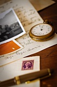 Still life with pocket watch, old letter and photograph