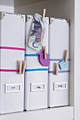 Box files with elastic bands & clothes pegs for holding notes