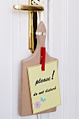 'Do not disturb' sign made from chopping board & clothes pegs