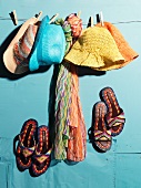 Colorful summer hats and scarves on a clothesline and ladies shoes
