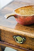 Antique wooden bowl on writing desk