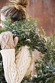 Woman carrying Christmas wreath
