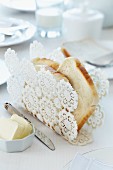 Crocheted doily moulded into original toast rack using fabric stiffener and starch on breakfast table