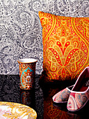 Cushion with oriental cover, ballerina pumps and beaker