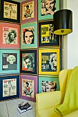 Collection of fifties portraits of women on wall behind retro standard lamp and yellow armchair