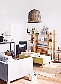 Modern living room with sofa, table, rug, ornaments on wooden shelves and basketwork lampshade