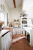 Kitchen-dining room with terracotta floor tiles in Mediterranean country house