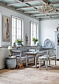 Country house dining room with wooden furniture and chandelier