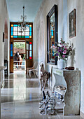 Hallway with vintage decorations, flowers and stained glass windows