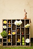 Rabbit figurine on top of large display case filled with cut flowers and ornaments