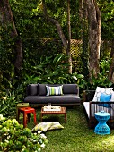 Various garden sofas with scatter cushions, small side tables and stools