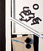 Framed canvas, black letters, strip light, paintbrush and black paint