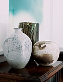 Collection of vases on small, antique cabinet