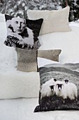 Fur cushions in snow, some printed with pictures