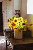 Vase of sunflowers on wooden console table in foyer