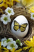 Egg with butterfly motif in Easter nest
