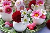 Easter table decoration with pink, red and white spring flowers