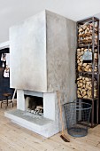 Steel shelves of firewood and concrete chimney breast with open fireplace in Scandinavian living room with pale spruce flooring