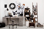 Black and white vintage decor, wooden crates, ladder and wall clock above concrete-effect desk; wood panelling used as pinboard