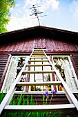 Ladder leading against Scandinavian wooden cabin